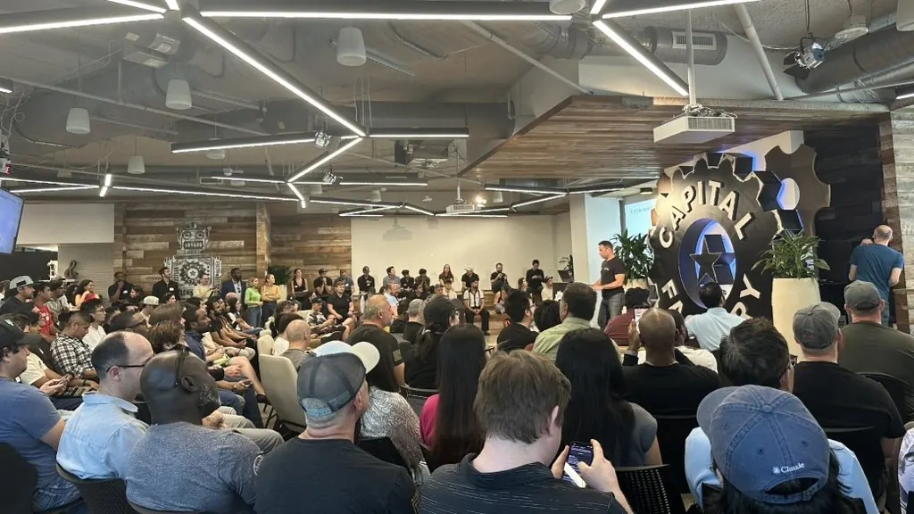 A packed audience at Capital Factory in Austin watching a speaker