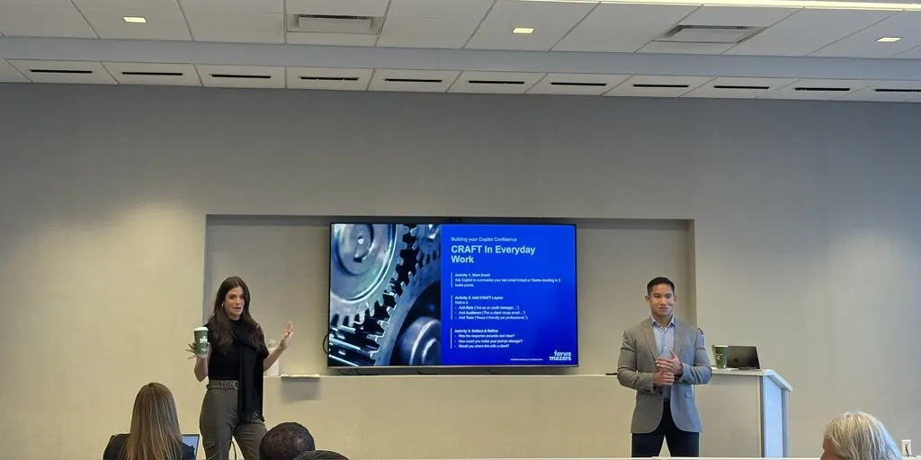Two facilitators presenting a slide on prompting in everyday work