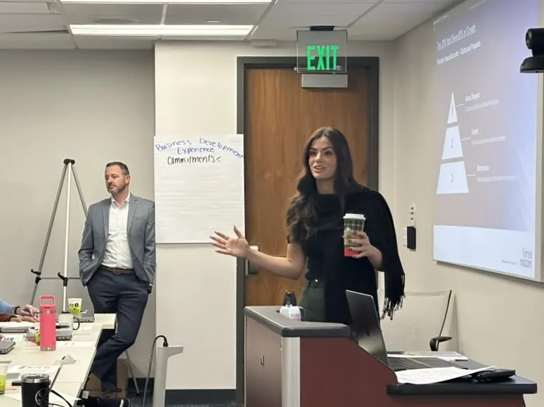 Two facilitators at the front of a training room