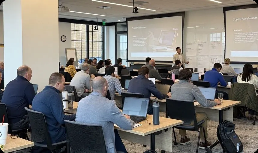 A full training room following along on laptops